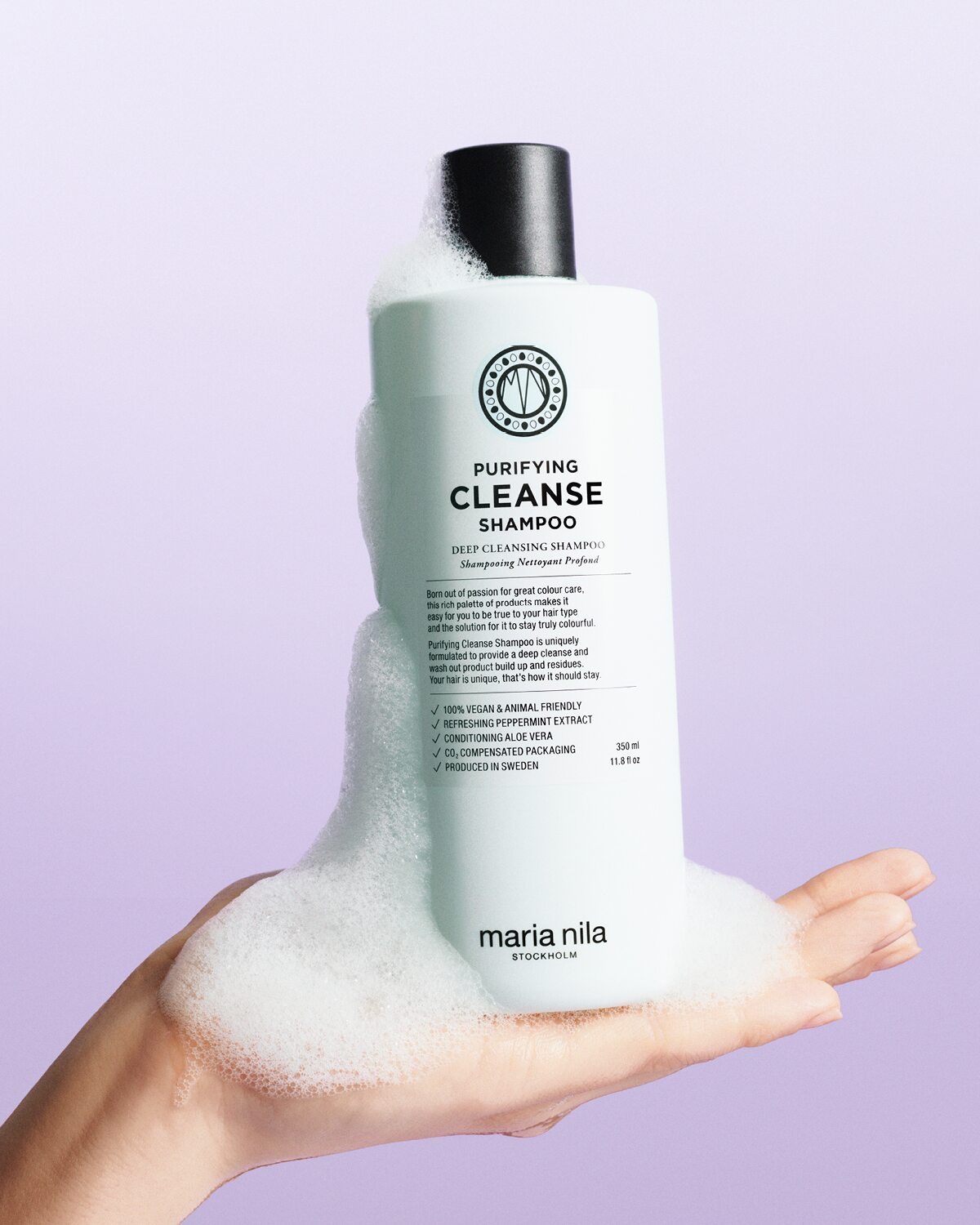 Purifying Cleanse shampoo bottle with lather