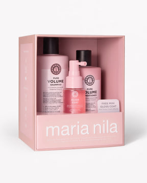 Maria Nila hair care gift set in a pink box, containing a Pure Volume Shampoo bottle, a Pure Volume Conditioner bottle, and a Gloss Coat pump bottle.