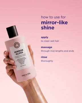Hand holding a bottle of Maria Nila Mirror Gloss Conditioner with instructions on a pink background