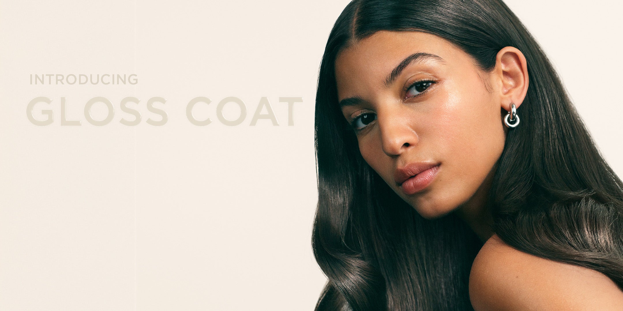 Model with glossy hair and text Introducing Maria Nila Gloss Coat