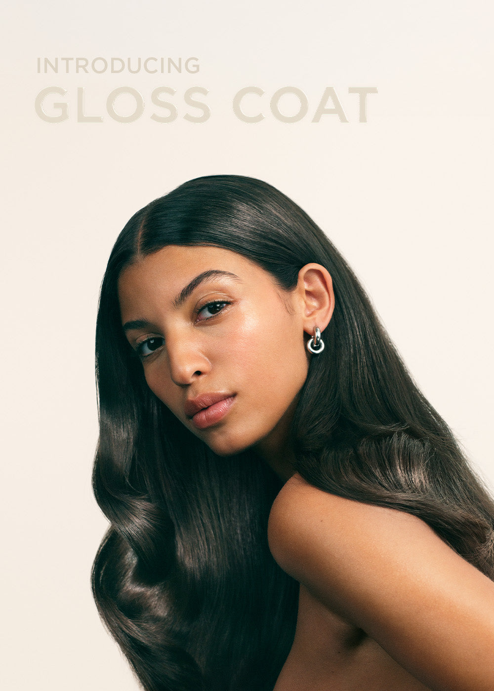 Model with glossy hair and text Introducing Maria Nila Gloss Coat